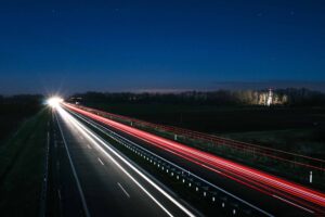 long exposure of car driving on road at night