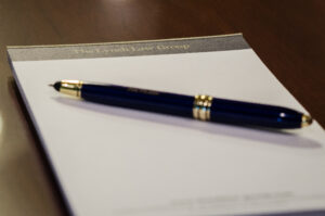 The Lynch Law Group notepad and pen