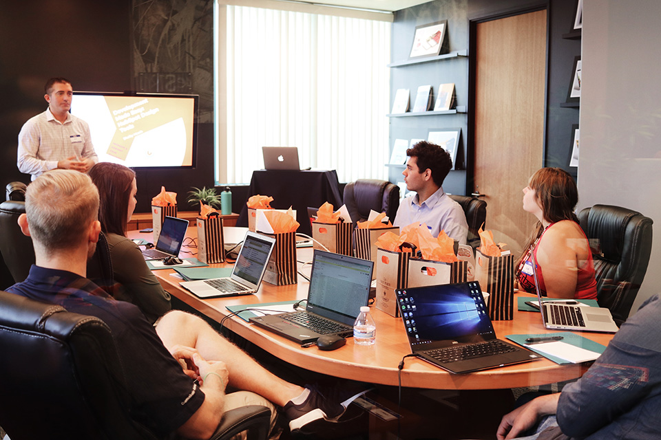 Employees discuss new FLSA overtime thresholds in conference room