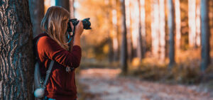Photographer shooting photos in the woods