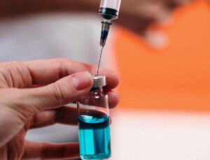 needle drawing covid-19 vaccine syrum from vial