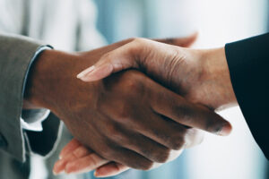 people in business attire shaking hands