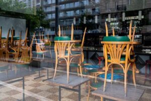 restaurant chairs stacked on tables in a closed storefront