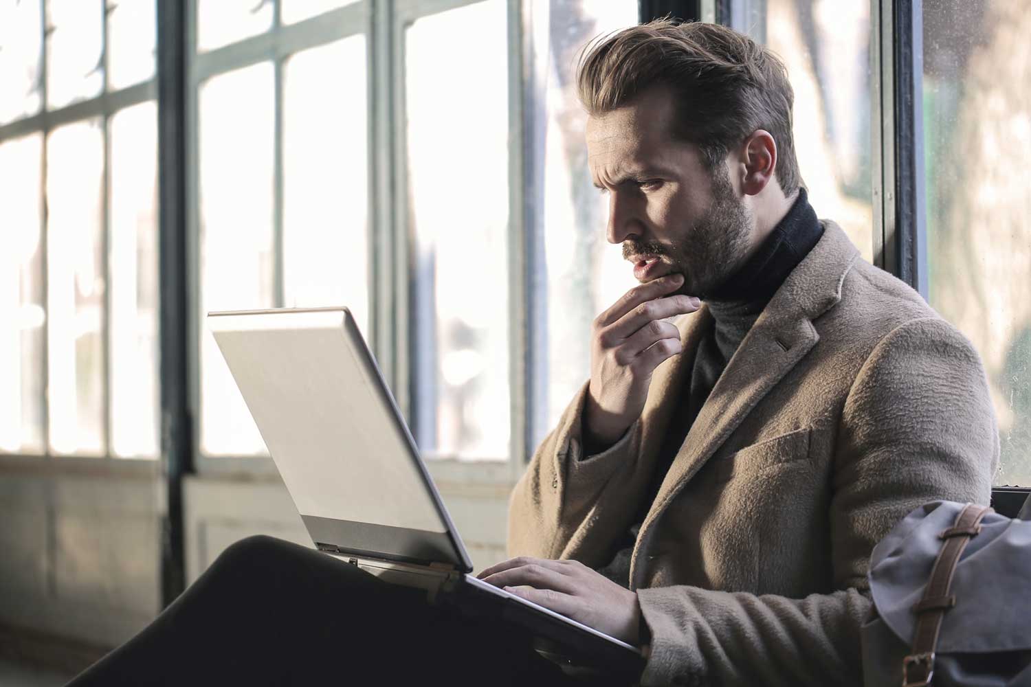 Upset man reading defamation on computer