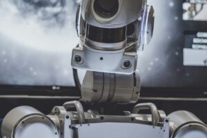 artificial intelligence or ai robot looking at a screen